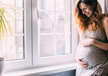 A pregnant woman smiling