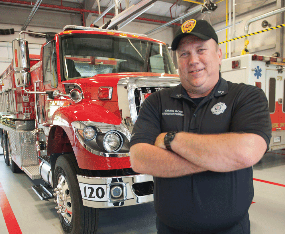 Picture of Craig in front of a fire truck